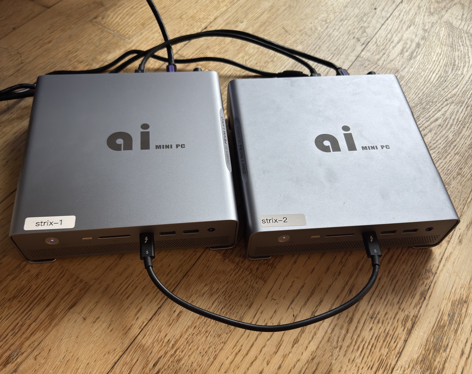 two Strix Halo mini-PCs (strix-1, strix-2) connected by USB4